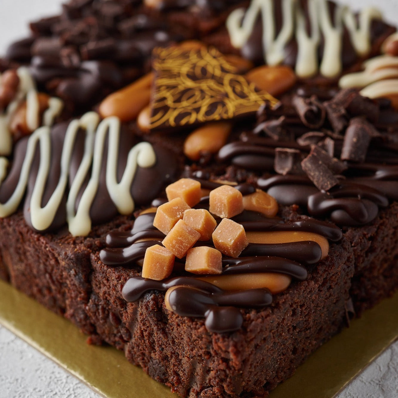 chocolate truffle cake squares with gooey caramel and fudge pieces