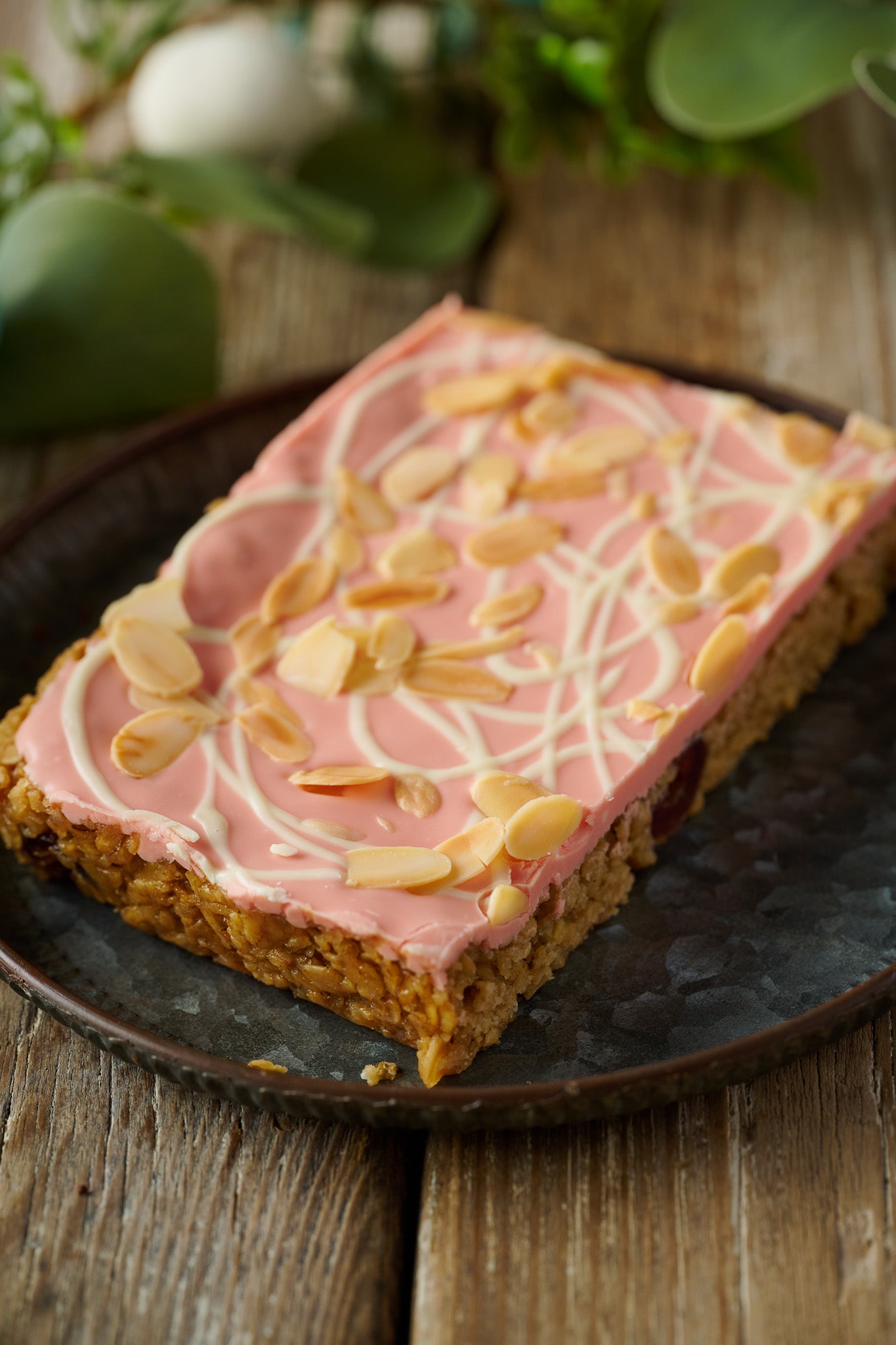 all butter almond flapjack topped with smooth pink chocolate topping, finished with flaked almonds