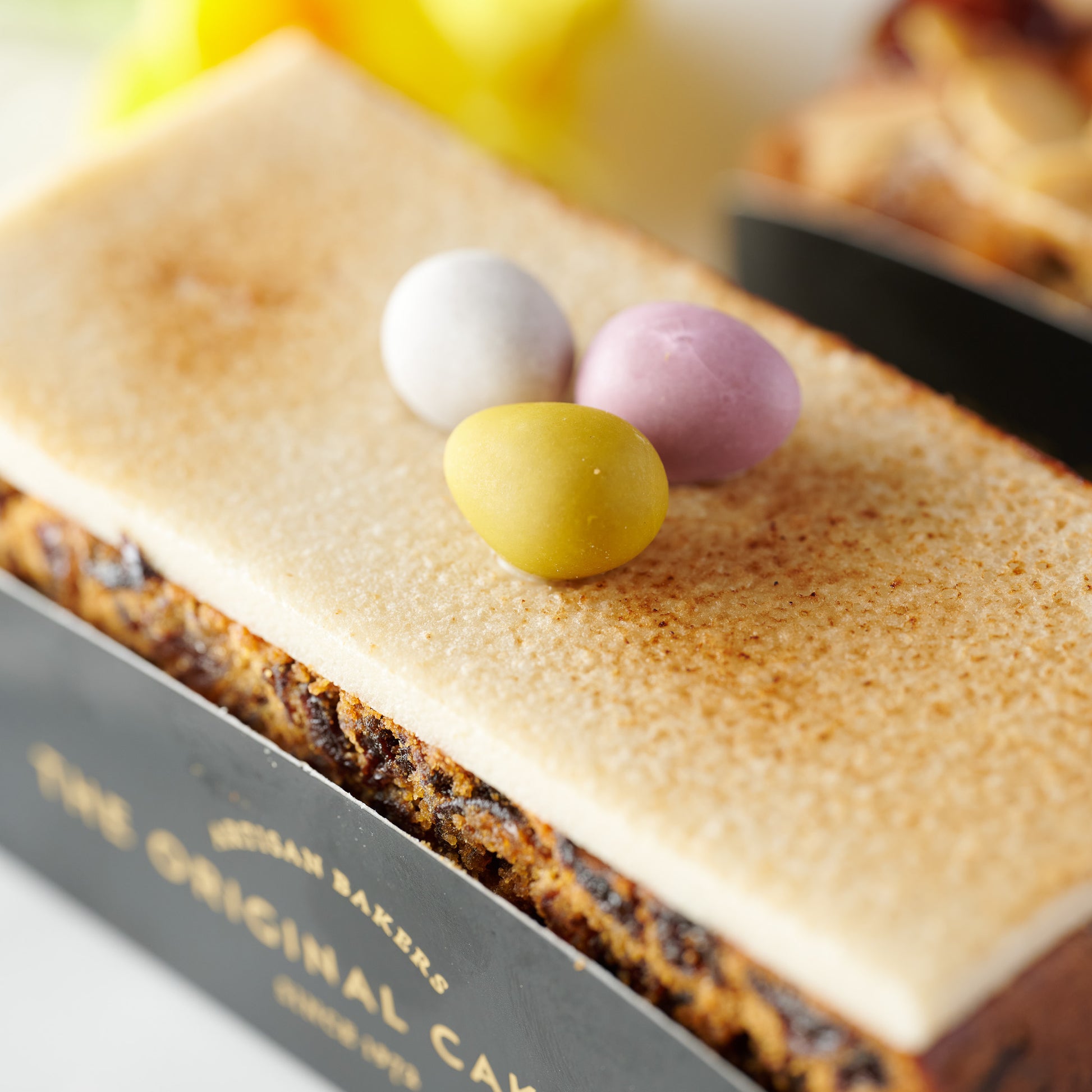 easter fruit cake topped with marzipan and mini chocolate eggs 