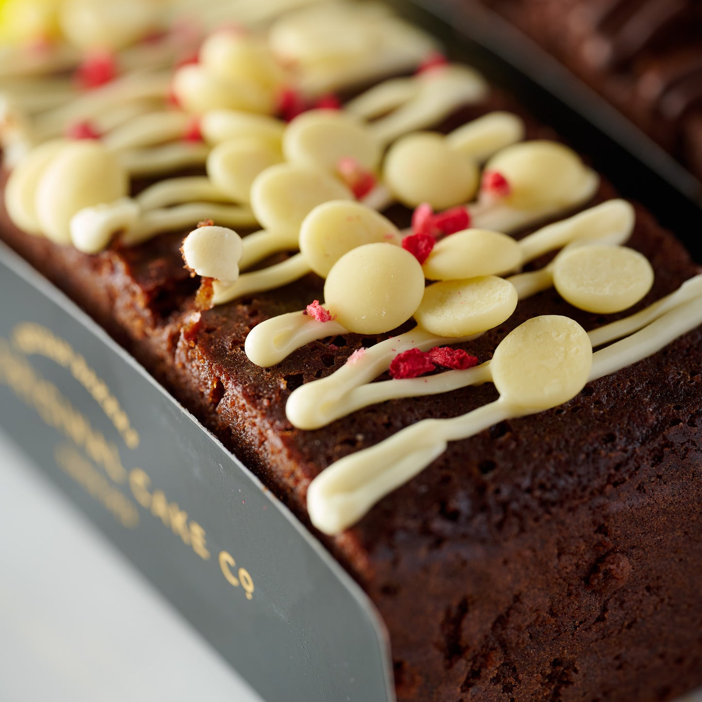 raspberry chocolate truffle cake topped with white chocolate 